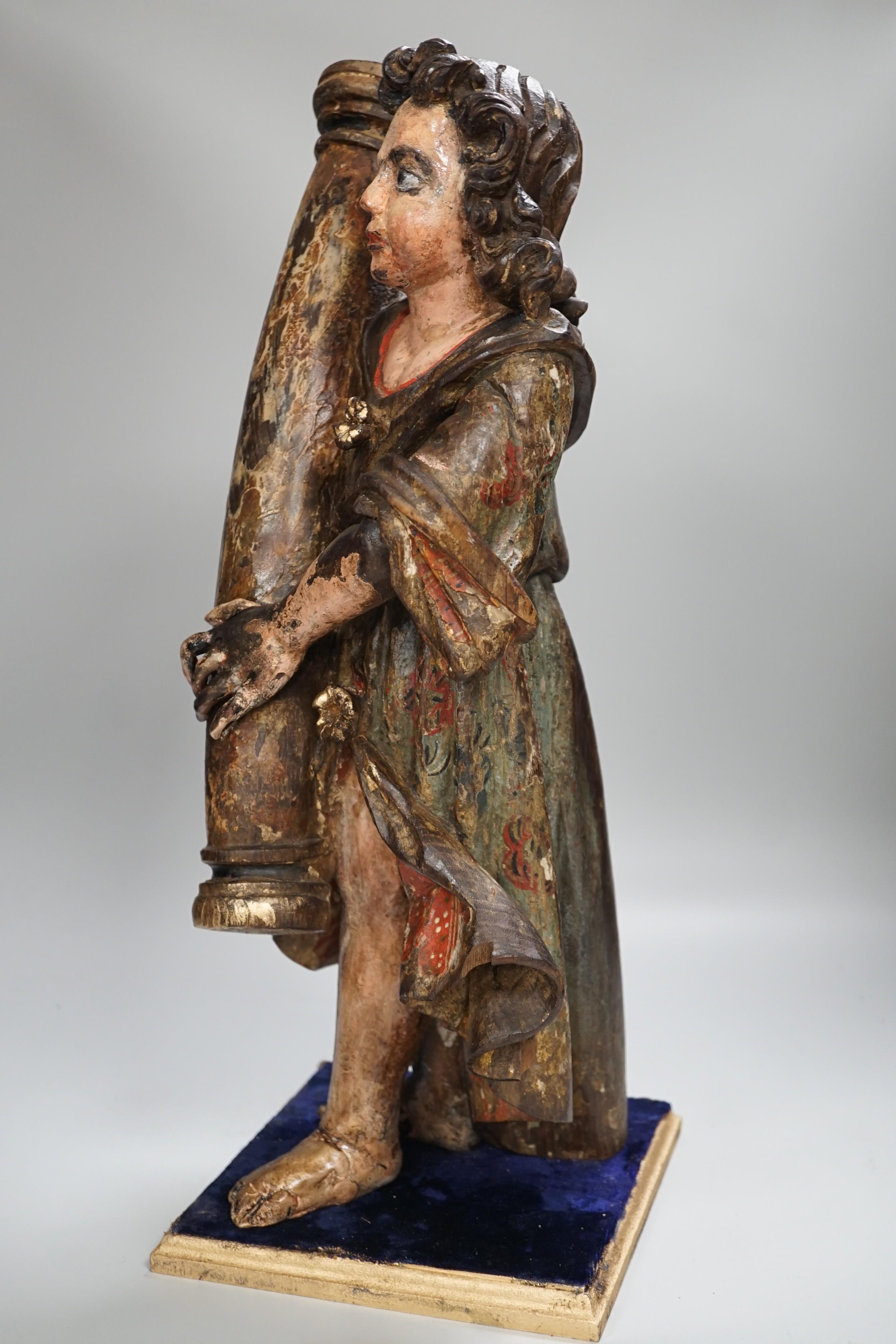 A carved wood polychrome model of a Saint, 53cm